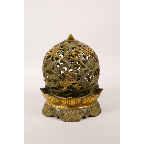 30 - A Chinese pierced bronze ball censer decorated with the eight Buddhist treasures, highlighted with g... 