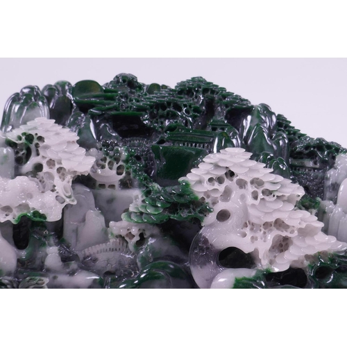 33 - A moulded reconstituted jade ornament depicting a mountainous landscape with temples, 8½