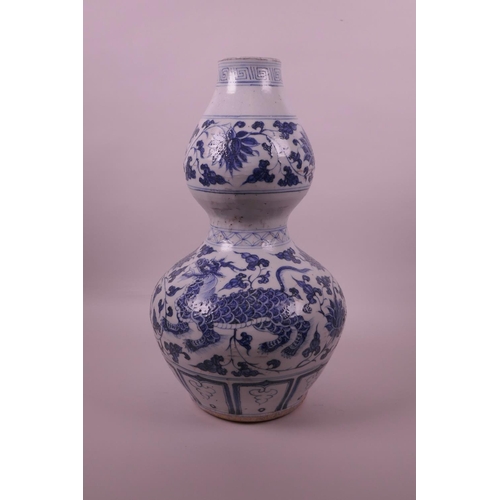 38 - A Chinese blue and white pottery double gourd vase decorated with lotus flowers and kylin, 13½