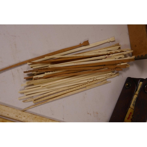 41 - A quantity of Chinese dyed bone gaming chips together with a box of bone and wood gaming sticks, a l... 