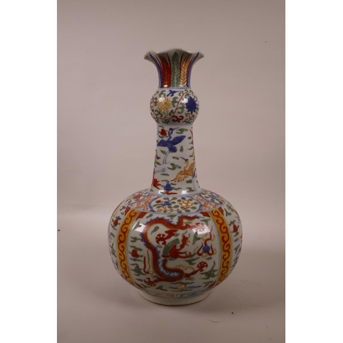 58 - A Chinese polychrome porcelain vase with a frilled rim, decorated with dragons and storks in flight,... 