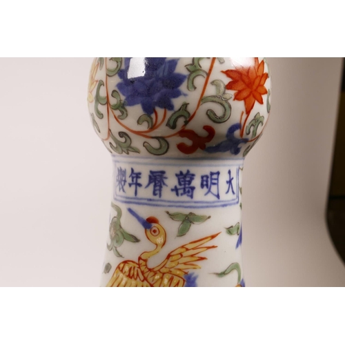 58 - A Chinese polychrome porcelain vase with a frilled rim, decorated with dragons and storks in flight,... 