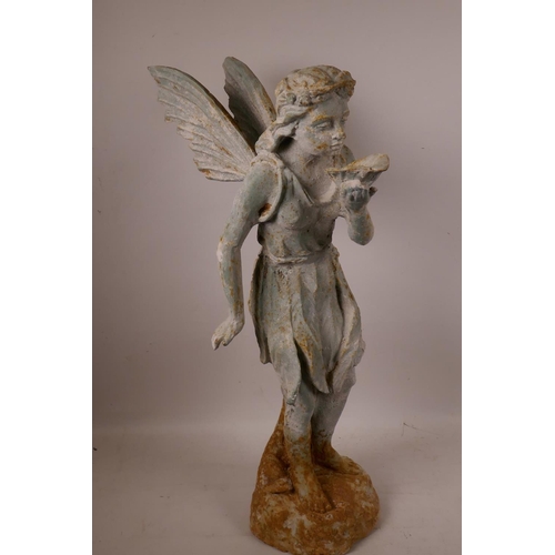 61 - A cast metal garden figurine of a fairy with cupped leaf, 20