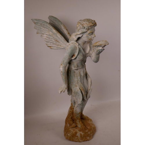 61 - A cast metal garden figurine of a fairy with cupped leaf, 20