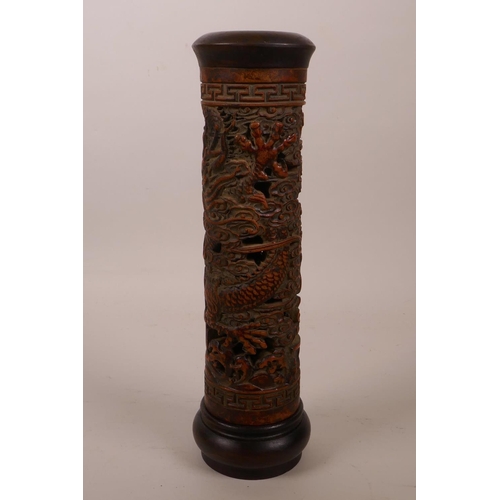 8 - A Chinese bamboo and hardwood cylinder incense burner with carved and pierced dragon decoration, 10