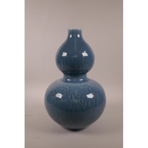 15 - A Chinese blue glazed double gourd vase with underglaze decoration of a fruiting gourd vine, seal ma... 