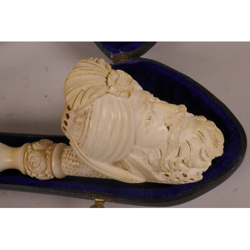 17 - A Meerschaum pipe, the bowl in the form of a turbaned Turk's head, the ring carved stem decorated wi... 