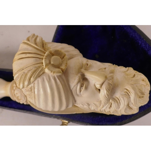 17 - A Meerschaum pipe, the bowl in the form of a turbaned Turk's head, the ring carved stem decorated wi... 