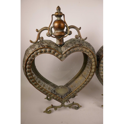 32 - A pair of decorative heart shaped candle lanterns with pierced bodies, 21