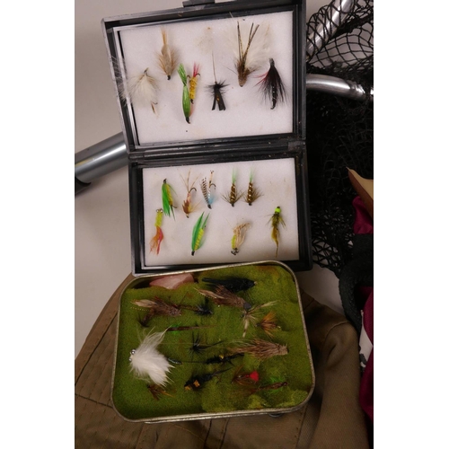 44 - A collection of fishing flies in three boxes and a tin, together with a landing net and a bog of mis... 