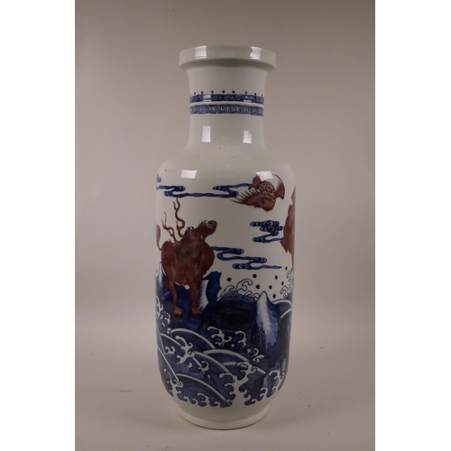 5 - A Chinese blue and white porcelain Rouleau vase decorated with mythical creatures in red, 17½