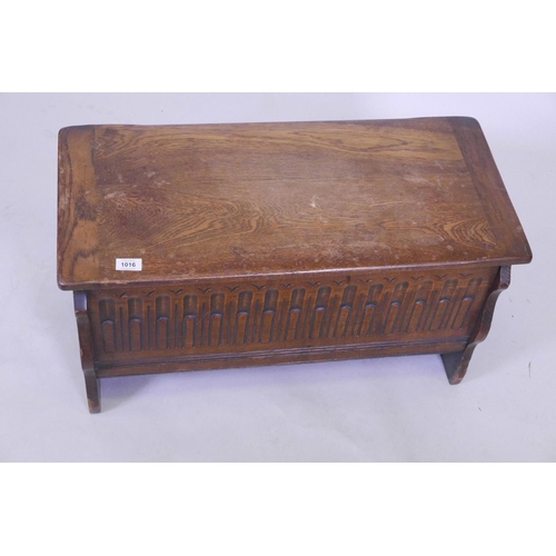 1116 - A small oak coffer, with carved front, 30