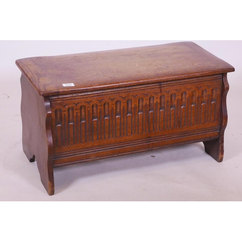 1116 - A small oak coffer, with carved front, 30