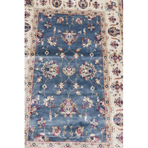 1132 - A Kashmiri duck egg blue rug decorated with a Ziegler design to centre and cream ground border, 51