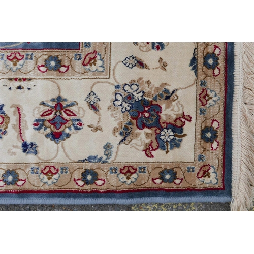 1132 - A Kashmiri duck egg blue rug decorated with a Ziegler design to centre and cream ground border, 51