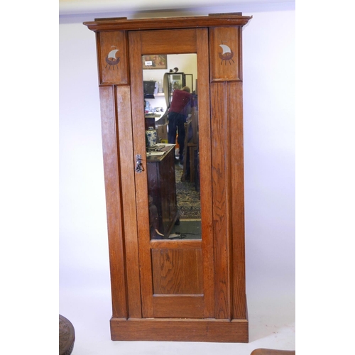 1119 - A Harris Lebus oak hall cupboard/wardrobe with pewter and exotic wood inlaid decoration, 37