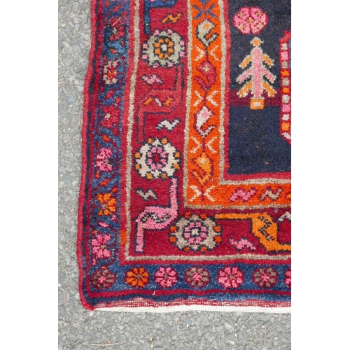 1133 - A red and blue ground Persian wool runner decorated with stylised birds and medallions, 46½