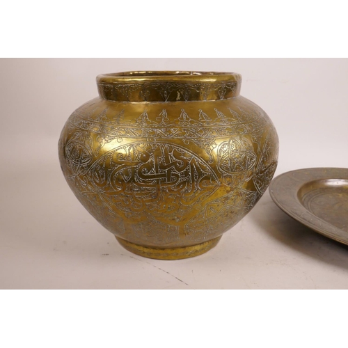 579 - An Islamic brass vase with engraved script decoration, together with an Islamic brass dish on three ... 