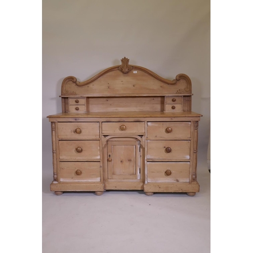 1102 - A C19th pine Lincolnshire dresser with seven drawers flanking a central cupboard, 62