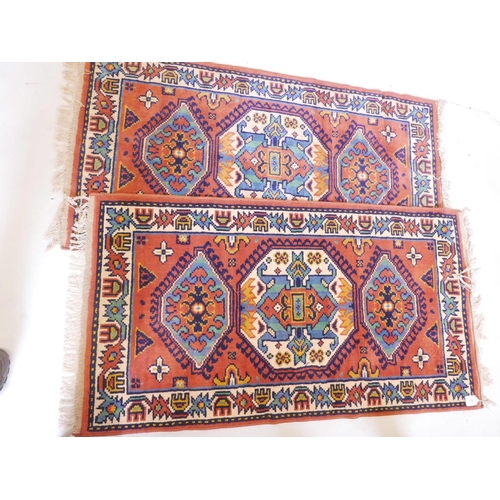 1106 - A pair of Oriental pattern Belgian wool rugs with red ground, 60