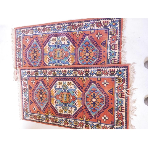 1106 - A pair of Oriental pattern Belgian wool rugs with red ground, 60