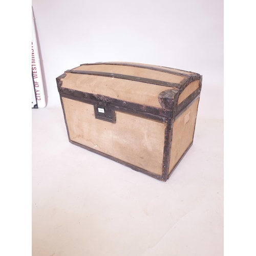 1110 - An iron banded, canvas covered, dome topped, wooden trunk, 17