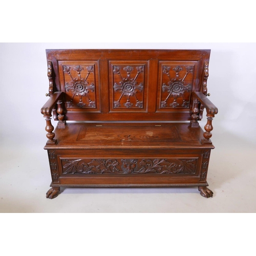 1111 - A Colonial, Anglo-Indian rosewood monk's bench, the three panelled back with carved decoration, and ... 