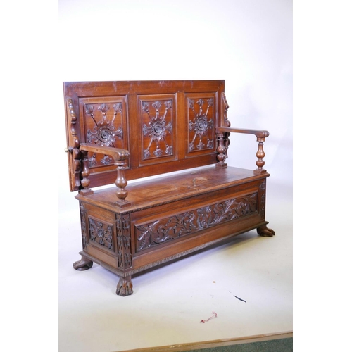 1111 - A Colonial, Anglo-Indian rosewood monk's bench, the three panelled back with carved decoration, and ... 