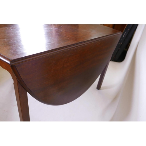 1113 - A Georgian mahogany drop leaf table, raised on chamfered supports, 44