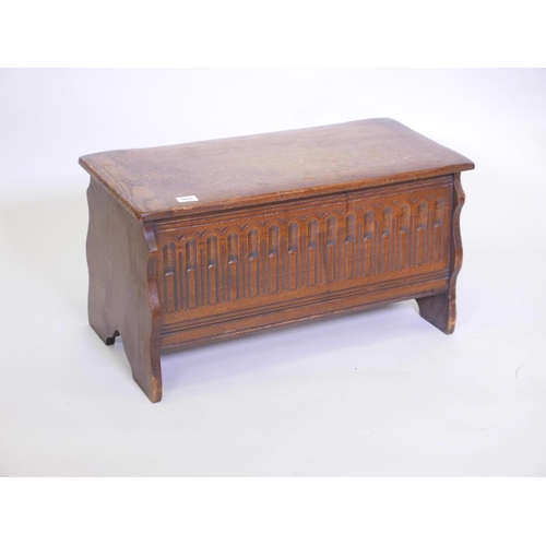 1116 - A small oak coffer, with carved front, 30