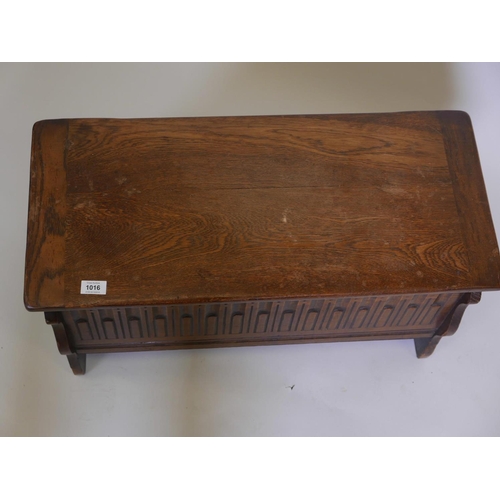 1116 - A small oak coffer, with carved front, 30