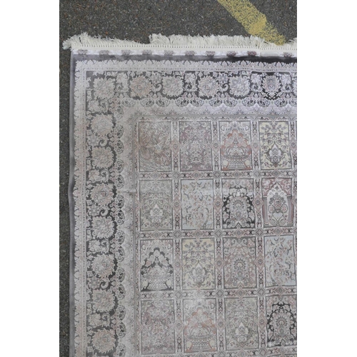 1128 - A pewter ground woven silk rug with a Persian panelled design with birds and flowers, 62