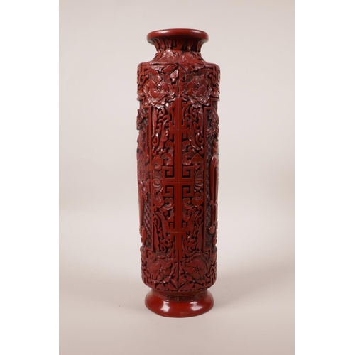 113 - A Chinese Cinnabar lacquer style cylinder vase with decorative panels, seal mark to base, 12½