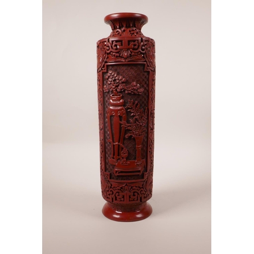 113 - A Chinese Cinnabar lacquer style cylinder vase with decorative panels, seal mark to base, 12½