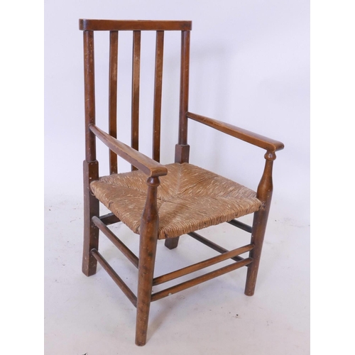 1146 - An Edwardian child's rush seated armchair, 25