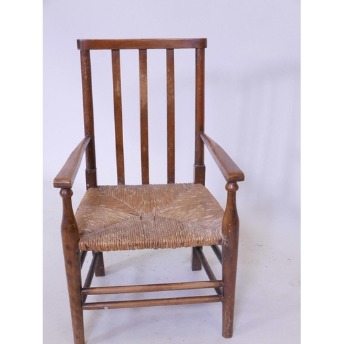 1146 - An Edwardian child's rush seated armchair, 25