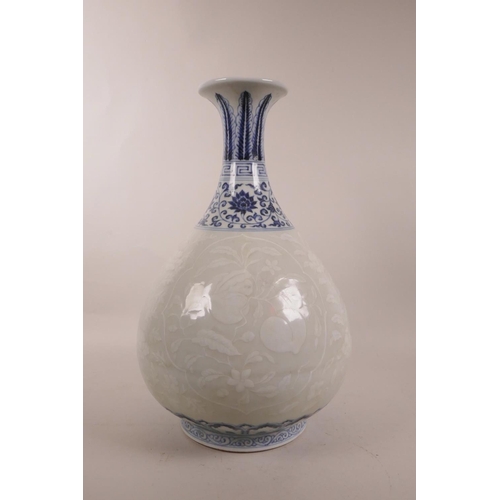 115 - A Chinese blue and white porcelain pear shaped vase with a flared rim, and white decoration of fruit... 