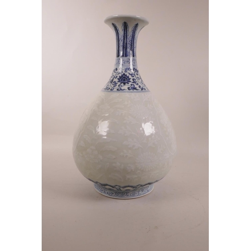 115 - A Chinese blue and white porcelain pear shaped vase with a flared rim, and white decoration of fruit... 