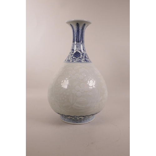 115 - A Chinese blue and white porcelain pear shaped vase with a flared rim, and white decoration of fruit... 