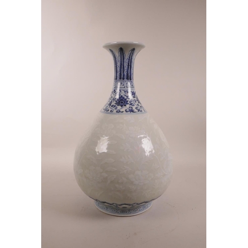 115 - A Chinese blue and white porcelain pear shaped vase with a flared rim, and white decoration of fruit... 