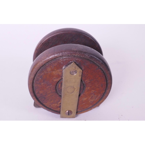 119 - A vintage English made wooden fishing reel with brass foot, 2½