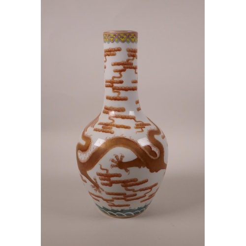 168 - A Chinese polychrome porcelain bottle vase decorated with a red and gilt dragon chasing the flaming ... 