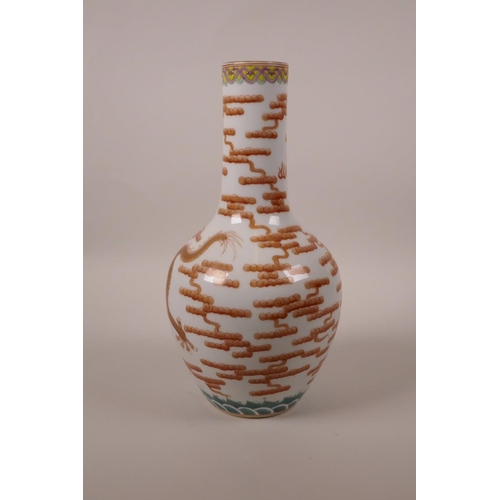 168 - A Chinese polychrome porcelain bottle vase decorated with a red and gilt dragon chasing the flaming ... 