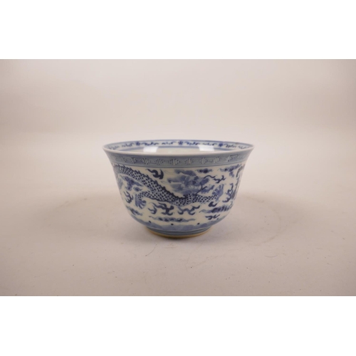 190 - A Chinese blue and white porcelain rice bowl decorated with dragons chasing the flaming pearl, seal ... 