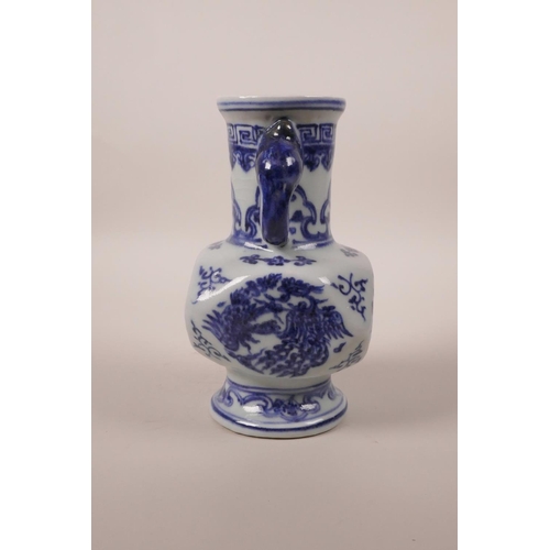 203 - A small Chinese blue and white pottery vase with two elephant mask handles and phoenix decoration, 6... 