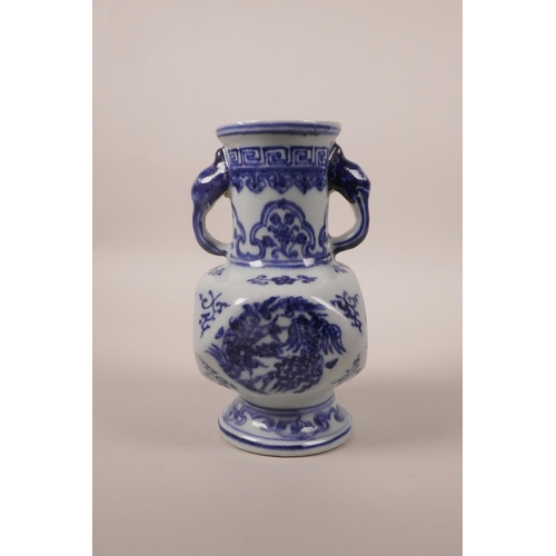 203 - A small Chinese blue and white pottery vase with two elephant mask handles and phoenix decoration, 6... 