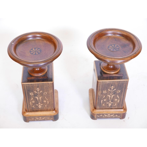 211 - A pair of rosewood and boxwood inlaid urns on stands, 10