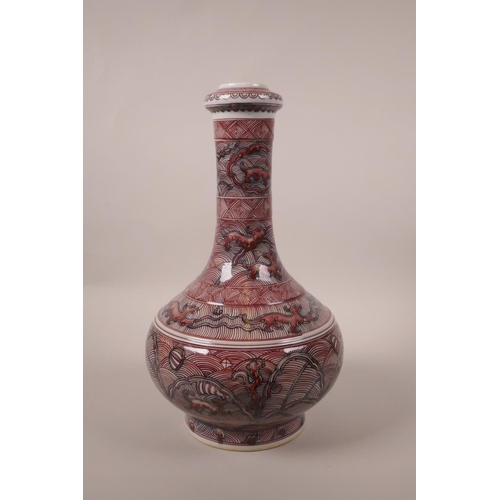 213 - A Chinese red and black porcelain bottle vase decorated with mythical creatures, 6 character mark to... 