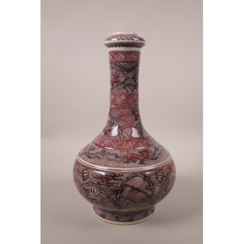 213 - A Chinese red and black porcelain bottle vase decorated with mythical creatures, 6 character mark to... 