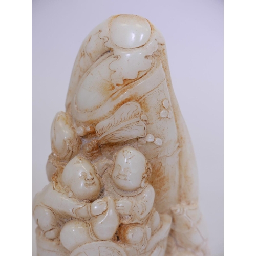 221 - A Chinese soapstone ornament decorated with boys playing, 11½